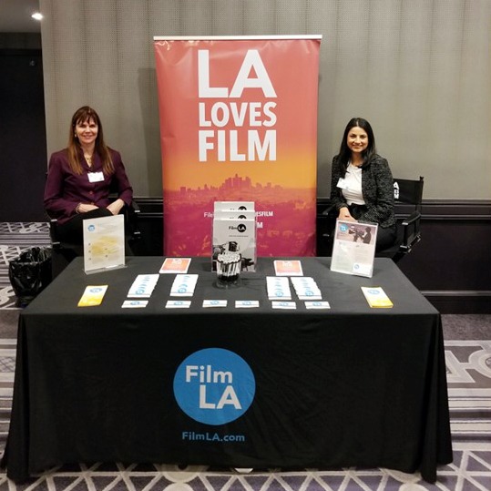 LA Loves Film sign and table with staff at event
